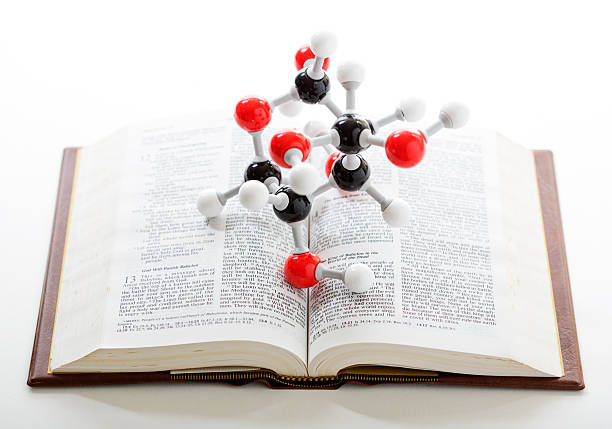 Concept for science versus religion, or evolution versus creationism. A molecular model on a bible.